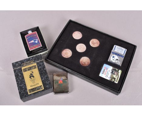 Sporting, a 2005 Super Bowl Champions 'The Cowboy' Zippo lighter and coin set, together with a 2021 New England Patriots exam