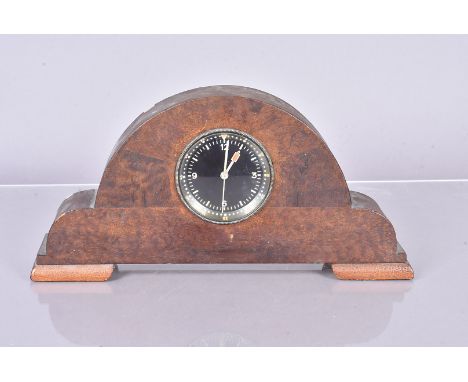 A military aviation Spitfire style cockpit clock, unstamped, mounted in a wooden mantel clock body 