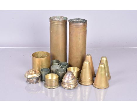 A collection of WWI and later shell cases, together with a timer fuse 