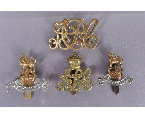 Royal Army Pay Corps (RAPC), four badges, including a 1898/00 in brass with two loops, an 01/20 Crowned APC example with slid