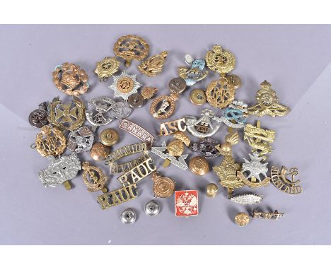 A collection of British and Overseas cap badges, comprising Royal Berkshire, Royal Artillery, Tank Corps, Sherwood Forresters