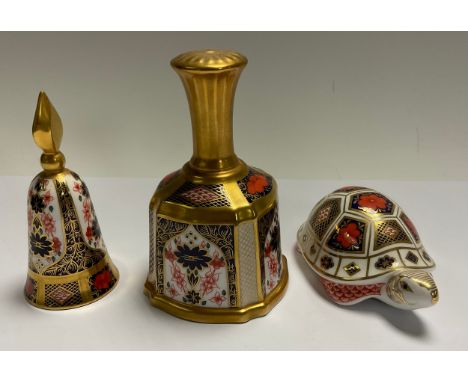 A Royal Crown Derby 1128 pattern bell, solid gold band, 14cm; an 1128 candle snuffer, 12cm; a Royal Crown Derby paperweight, 