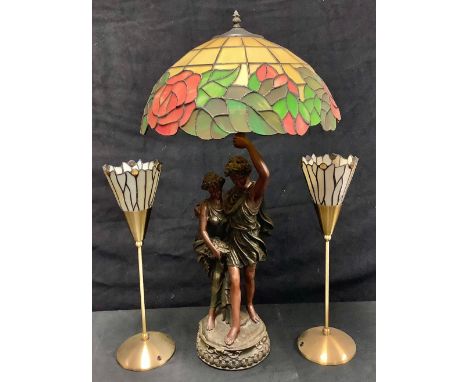 A table lamp, the resin moulded support as a classical couple, "Tiffany" style glass shade, 81cm; a pair of lacquered brass a