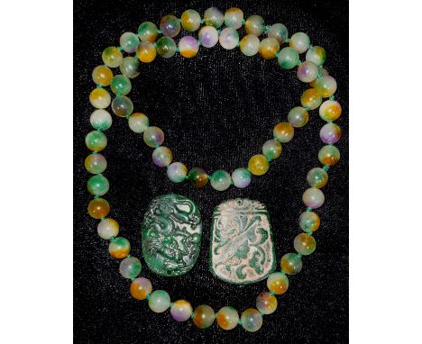 A pair of jade pendants; a string of jade beads (3) 