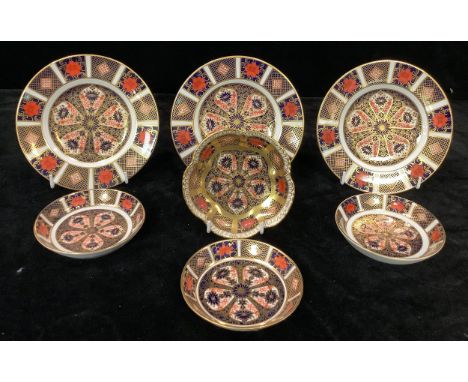 A set of three Royal Crown Derby 1128 pattern tea plates, one first, two seconds, 16cm; four 1128 pattern trinket trays, thre