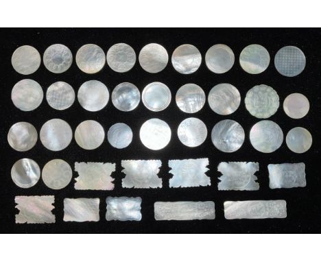 A collection of 19th century Cantonese mother of pearl gaming tokens of various shapes and sizes, engraved with birds, foliag