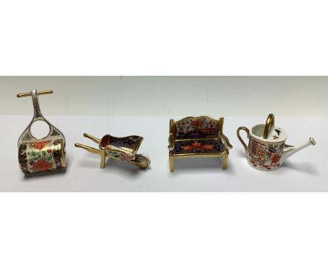 A Royal Crown Derby miniature Imari palette model, Garden Bench, first quality; others, Garden Roller, Watering can and Wheel