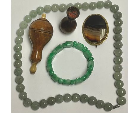 An agate brooch; a jade bracelet; a string of hardstone beads; a 19th century desk seal; a turned treen bell-push (5) 