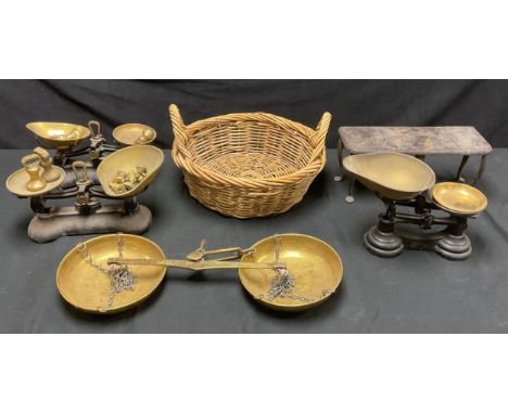 A set of brass hanging balance scales; a set of brass and cast metal kitchen scales, with brass weights; others similar; an i