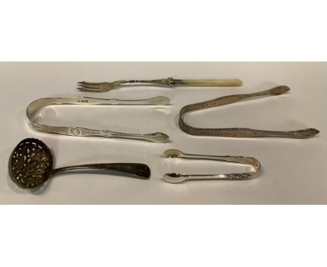 A pair of silver sugar bows; another; a silver and mother-of-pearl pickle fork, etc (5) 