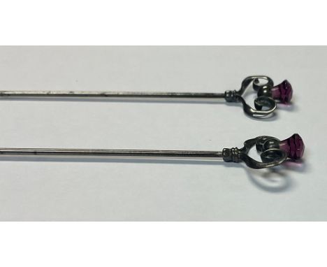 A pair of sterling silver hat pins, by Charles Horner, open scroll work amethyst thistle terminals, steel pins, 16.5cm, c.190
