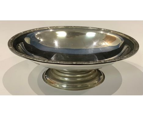 An Elizabeth II silver oval pedestal bon-bon dish, the border cast with entwined Celtic serpents, interspersed with roundels,