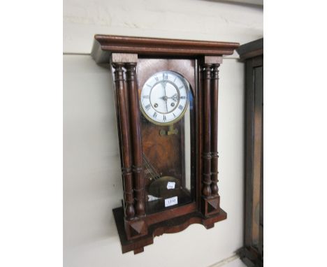 Small walnut cased Vienna style wall clock, the case with twin turned pilasters enclosing an enamel dial with Roman numerals 