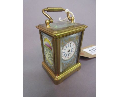 20th Century miniature brass cased carriage clock with circular enamel dial, Arabic and Roman numerals inset with porcelain p