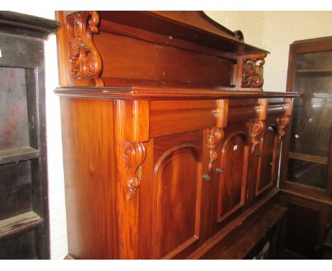 Reproduction mahogany chiffonier, the shelf back with carved surmount above three drawers and three dome topped panelled door