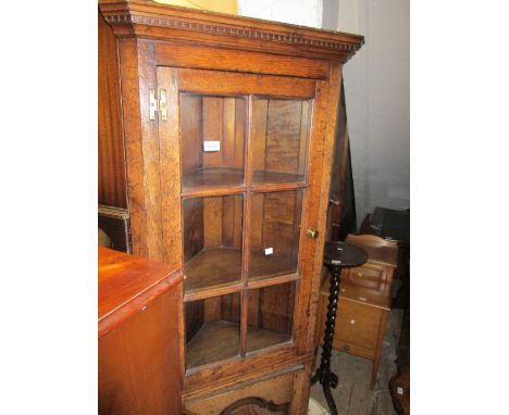 Good quality reproduction oak floor standing corner cabinet having bar glazed top above a single fielded panelled door on bra