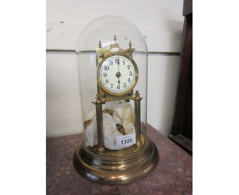 Brass three hundred day clock with enamel dial and Arabic numerals beneath a glass dome