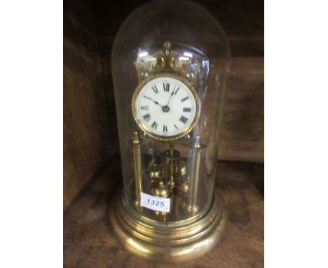 Brass three hundred day clock with enamel dial and Roman numerals beneath a glass dome