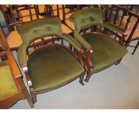 Pair of late 19th / early 20th Century mahogany tub shaped chairs having green upholstery, with spindle backs raised on turne