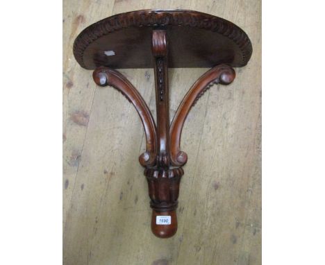Reproduction mahogany wall bracket with carved decoration and another mahogany wall bracket