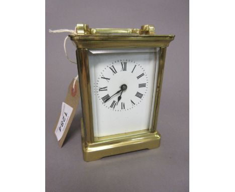 Small brass cased carriage clock, the enamel dial with Roman numerals and single train movement