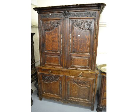 Early 19th Century French oak buffet de corps, the carved moulded cornice above carved frieze and two panel doors, the base w