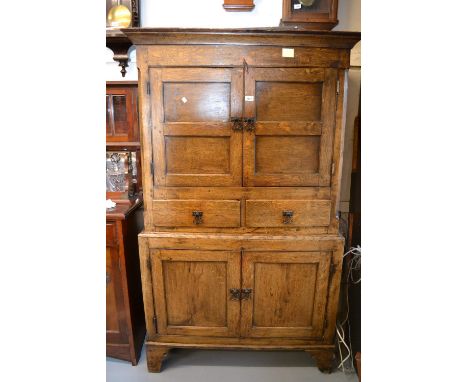 18th Century oak bacon cupboard, the moulded cornice above a pair of panelled doors, two drawers and two further panelled doo