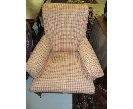 Victorian upholstered library armchair covered in a red check fabric on low turned supports with brass and ceramic casters