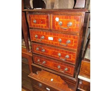 Reproduction mahogany bedside chest having two short drawers above three long drawers with brass swan neck handles on bracket