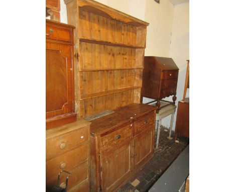 19th Century stripped and polished pine dresser with a boarded shelf back above two drawers and two panelled doors