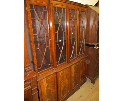 Small good quality reproduction mahogany breakfront bookcase, the moulded dentil cornice above four astragal glazed doors enc