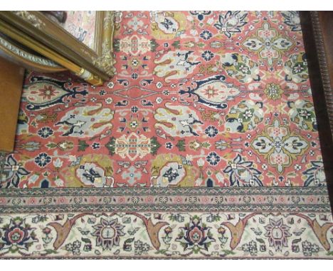 Turkish Hereke carpet with an all-over stylised floral design on a pink ground with borders, 9ft 6ins x 6ft 2ins approximatel