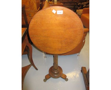 19th Century circular tilt top table on brass paw feet and a 19th Century rosewood two division tea caddy (at fault)