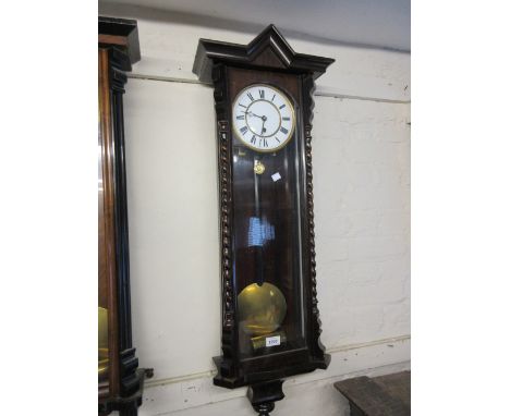 Vienna type wall clock with a stained wooden case with spiral twist half columns, the enamel dial with Roman numerals with a 