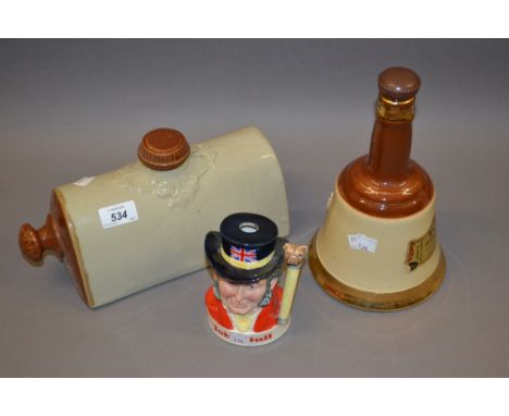 Royal Doulton whisky decanter, a Wade Bells decanter and a stoneware hot water bottle