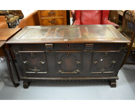 17th Century oak coffer, the hinged three panel lid above a three panel front decorated with applied mouldings and carving ab