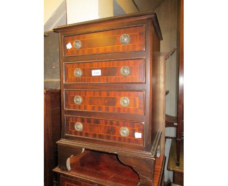 Reproduction mahogany line inlaid bedside chest of four drawers with circular brass ring handles on bracket feet