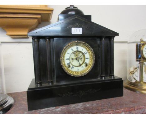 19th Century black slate mantel clock having circular dial with white chapter ring and Roman numerals with visible escapement