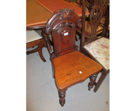 Victorian carved mahogany hall chair with a shield back above a panel seat and turned front supports