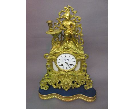 19th Century French ormolu mantel clock, the shaped case with a figural and candlestick surmount, the circular white enamel d