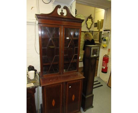 Small Edwardian mahogany satinwood crossbanded line and lunette inlaid bookcase with a broken arch pediment above a pair of a