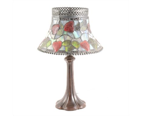 A Tiffany style table lamp, stained leaded shade, on a petal base, height 50cm.
