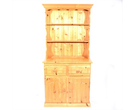 A small pine dresser, two shelf delft rack, the base with two drawers over two doors, width 87cm, height 183cm.