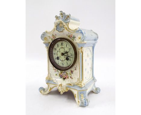 French pottery two train mantel clock striking on a gong, within an ornate transfer printed floral case, 11" high