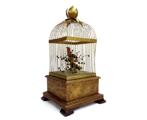 Gilt metal and giltwood singing bird musical automaton, with two feathered perched birds amidst foliage, within a wirework ca