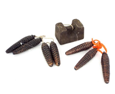 Seven similar size Black Forest clock weights; also another weight (8)