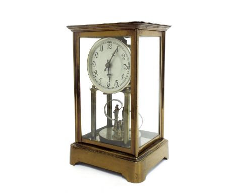 Brass four glass torsion clock, the 3.75" silvered dial upon two pillars and over a disc pendulum, within a glazed stepped ca