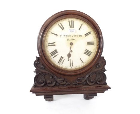 Mahogany 12" wall dial clock signed Pleasanse & Harper, Bristol, within a turned surround over applied scrolling foliate carv