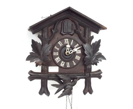 Black Forest two train cuckoo clock, the 4.5" dial within a chalet case carved with birds and vine leaves, 23" high (pendulum