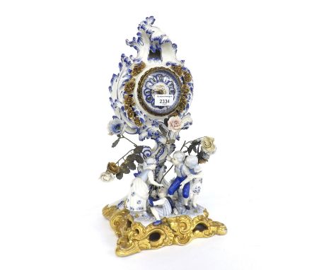 Italian blue and white porcelain mantel timepiece, the 3" dial within a rococo surround over three children playing on a pier